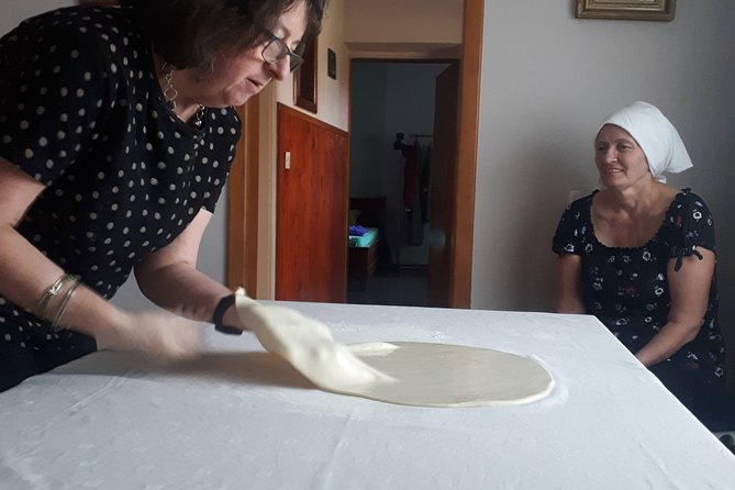 Balkan pita making culinary experience - Stretching Balkan pita in a village home